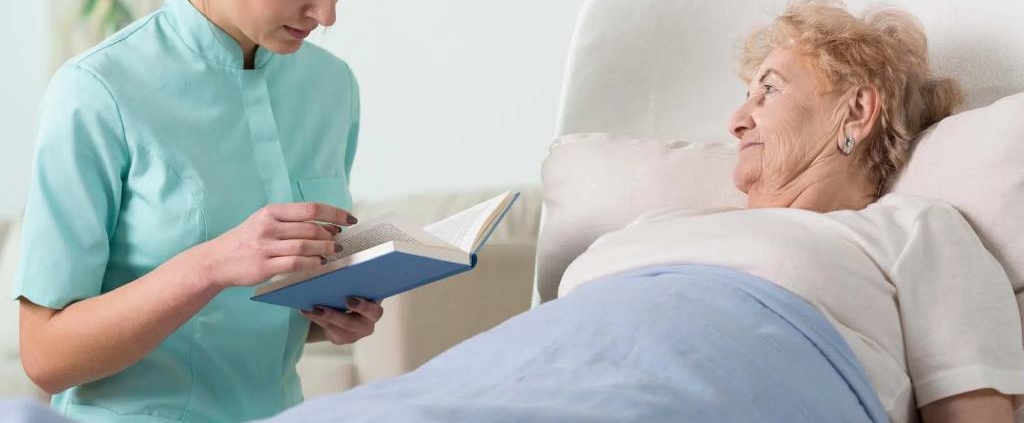 24/7 senior caregiver in CT, reading a book.